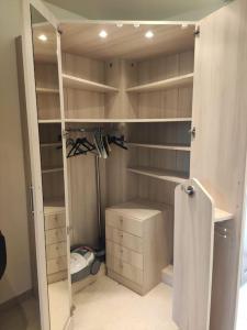 a bathroom with a walk in closet with shelves at Studio belles prestations en Cévennes in Chamborigaud