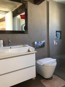 a bathroom with a sink and a toilet and a mirror at House of Character in Historical Rabat in Rabat