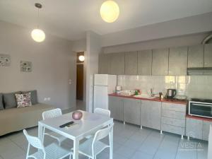 a kitchen with a table and chairs in a room at 4 apartments in Hanioti in Hanioti