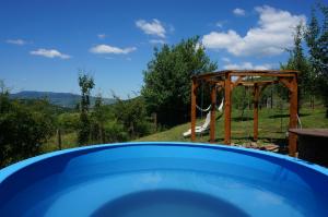 a swimming pool with a gazebo in a yard at Natura Chalets in Praid