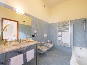 a bathroom with a sink and a toilet and a mirror at Hotel Il Duca d'Este in Ferrara