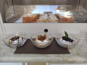 three bowls of desserts on a counter in a bakery at ELISEO PALACE TROPEA in Tropea