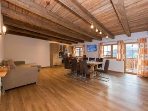 a large living room with a table and chairs at Apartment in Kaprun with Ski-in Ski-out Access in Kaprun