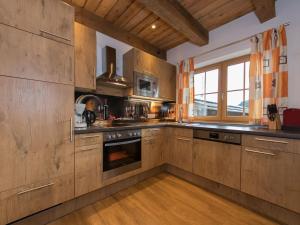 a kitchen with wooden cabinets and an oven at Apartment in Kaprun with Ski-in Ski-out Access in Kaprun +31 photos