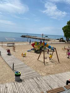 a beach with children playing on a playground at Royal Grand Hotel and Spa - All Inclusive and Free beach accsess in Kavarna