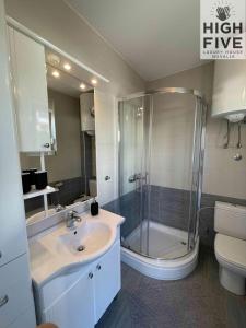 a bathroom with a shower and a sink and a toilet at Apartment High Five Novalja in Novalja +25 photos