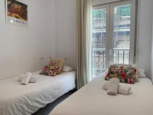 Кровать или кровати в номере Homely Málaga Atarazanas