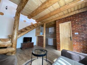 a living room with a couch and a brick wall at Sumska bajka in Žabljak