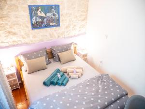 a small bedroom with a bed and pillows on it at ~Melody Room ~ with Breezy & Silent Ambience in Hvar
