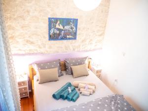 a small bedroom with a bed with pillows at ~Melody Room ~ with Breezy & Silent Ambience in Hvar