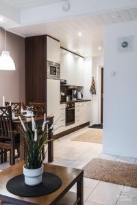 a kitchen and living room with a table and a dining room at Holiday In Lapland - LeviStar II 312 in Levi