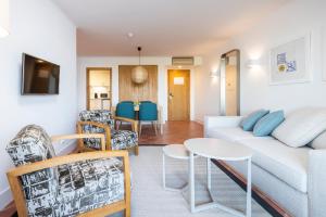a living room with a couch and chairs and a table at The Patio Suite Hotel in Albufeira