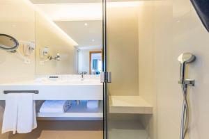 a bathroom with a sink and a shower at The Patio Suite Hotel in Albufeira