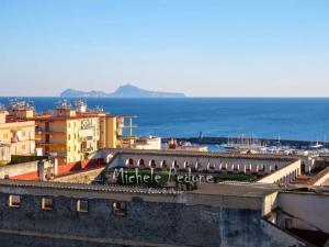 a view of a city with the ocean and buildings at La Via del Mare in Torre del Greco