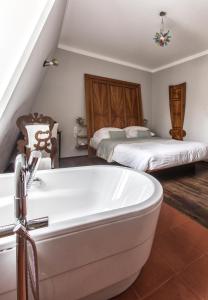 a bathroom with a bath tub and two beds at Design Hotel Neruda in Prague