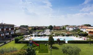 a resort with a playground and a swimming pool at Gardappartamenti Benacus Sirmione in Sirmione