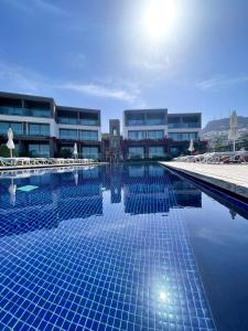 a large swimming pool in front of a building at Costa Farilya Special Class Hotel Bodrum in Gundogan
