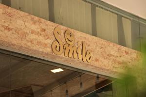 a sign on the front of a store at Hotel Smile in K'obulet'i