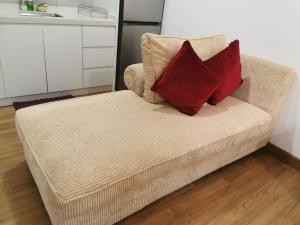 a couch with two pillows on it in a kitchen at Apple Home 2 at Menara Simfoni, King Size Bed, Cheras, Nexflix, Wifi, Parking in Seri Kembangan