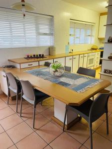 a kitchen with a large wooden table and chairs at Stella Maris Apartment 132 in Amanzimtoti