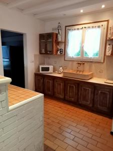 cocina con fregadero y microondas en gite a st germain sur ay, en Bretteville-sur-Ay