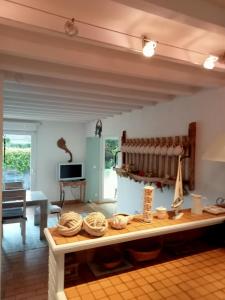 a living room with a table with baskets on it at gite a st germain sur ay in Bretteville-sur-Ay