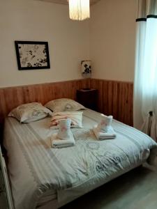 a bedroom with a large bed with towels on it at gite a st germain sur ay in Bretteville-sur-Ay