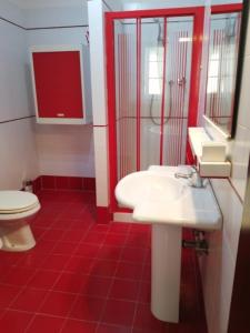 a bathroom with a white sink and a toilet at Borgo Creativo in Montopoli in Val dʼArno