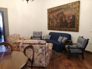 a living room with a couch and a painting on the wall at Borgo Creativo in Montopoli in Val dʼArno