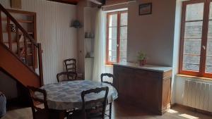 a dining room with a table and a table and chairs at maison avec jardin in Sylvanès