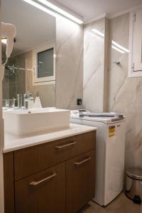 a bathroom with a sink and a counter with a refrigerator at CENTRAL ROOF NK CHANIA in Chania