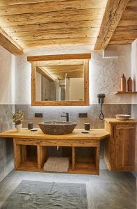 a bathroom with a sink and a large mirror at Keramikhaus Gmunden in Gmunden