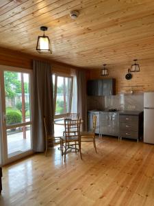 a kitchen and dining room with a table and chairs at Cottage Gageta in Ureki