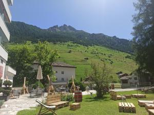 a resort with a green hill in the background at Haus Zerfreila in Vals