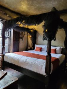 a bedroom with a large bed in a room with at Hocus Pocus Tiny Hotel in York