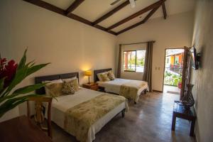 Uma cama ou camas num quarto em Conchal Hotel