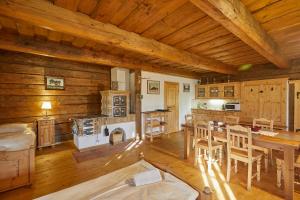 a kitchen with a table and chairs in a cabin at Volarská roubenka in Volary +23 photos