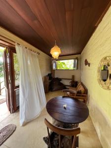 um quarto com uma mesa e cadeiras e uma janela em Casa Fufi em Jericoacoara