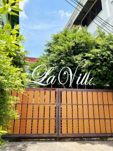 a gate with the word vaculum written on it at Hotel La Villa Khon Kaen in Khon Kaen