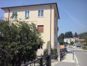 a building with a fence in front of a street at Warm, nice & amazing Lake-view apartment in San Zeno di Montagna