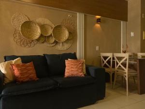 a living room with a blue couch and a table at Flat Beira Mar- Ap 306 #ELEGANCE in Natal