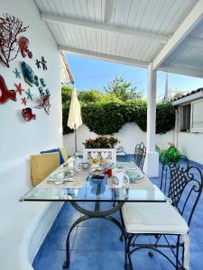 a glass table and chairs on a patio at La Bicocca di Annavì in Forio d'Ischia