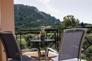 a table and chairs on a balcony with a view at Casa Armonia Zakynthos: 2-Floor Residence in Gaïtánion