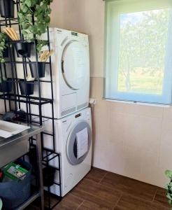 a washing machine in a room with a window at Camp Genys in Jurbarkas
