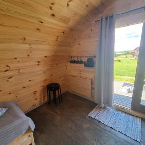 a room with a wooden wall with a window at Camp Genys in Jurbarkas