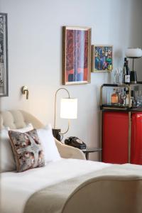 a bedroom with a bed and a table with a lamp at Virgin Hotels Edinburgh in Edinburgh