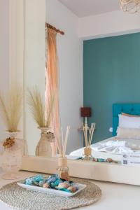 a bedroom with a mirror and a tray with rocks at Kissamos sea view beach apartments in Kissamos