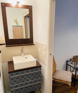 La salle de bains est pourvue d'un lavabo et d'un miroir. dans l'établissement Perle Rare , sur La Rochelle Appartement avec parking, à La Rochelle