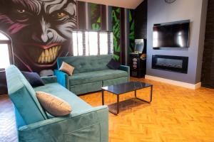 a living room with a couch and a table and a painting at Withnell Stays - Apartment Six in Blackpool