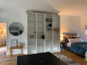 a bedroom with a large white book shelf next to a bed at Ralf's Coastal Shack in Marlo